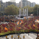 People form a "V" for "vote" in red and yellow, the colors of the Catalan flag, during a gathering to mark the Calatalonia day "Diada" in central Barcelona